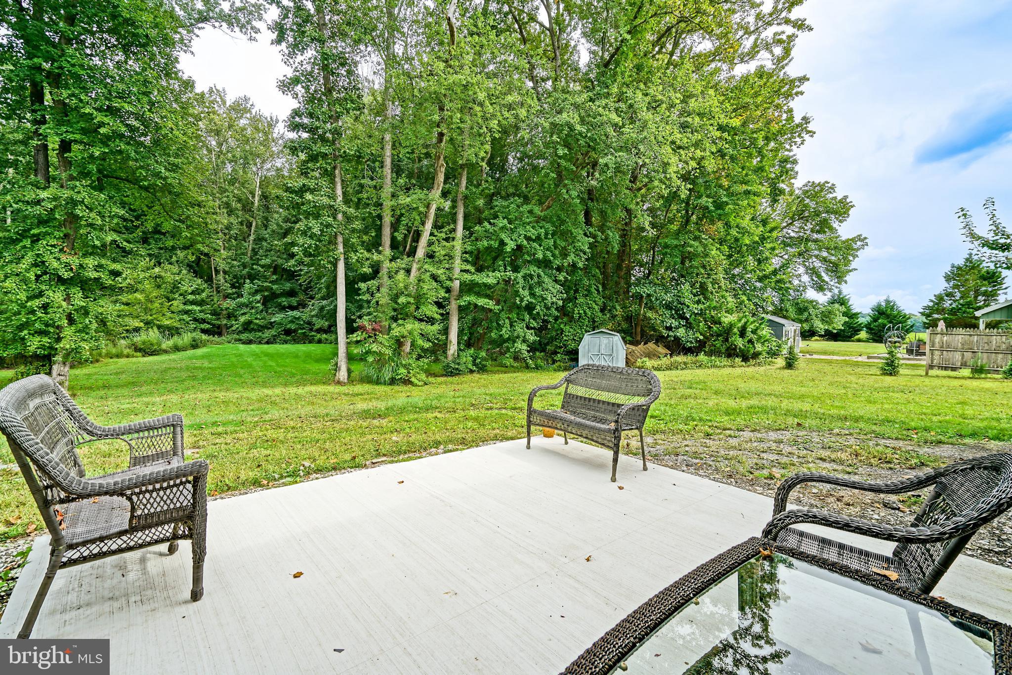 18897 Sand Hill Road Milton, DE 19968 - Photo 37 of 51 a park with a bench and trees in the background