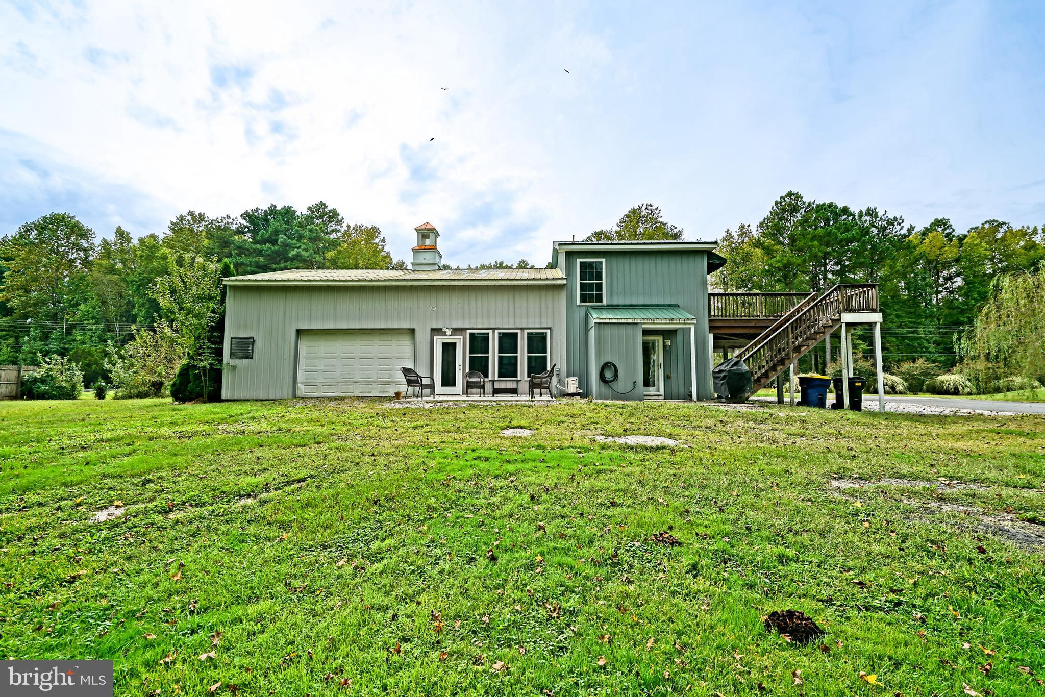 18897 Sand Hill Road Milton, DE 19968 - Photo 43 of 51 a front view of a house with a garden