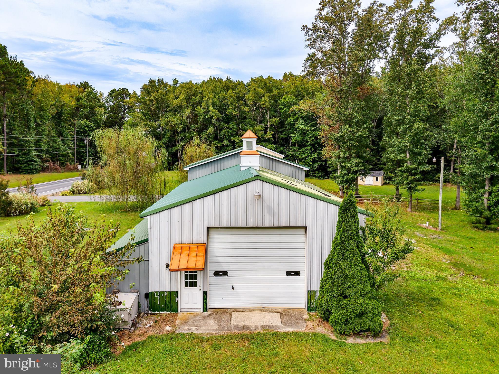 18897 Sand Hill Road Milton, DE 19968 - Photo 50 of 51 a aerial view of a house with a yard table and chairs