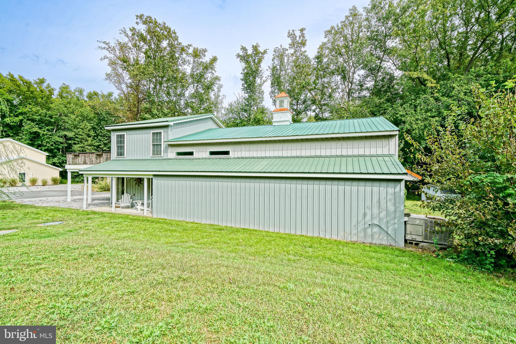 18897 Sand Hill Road Milton, DE 19968 - Photo 5 of 51 a view of a house with a yard and a large tree