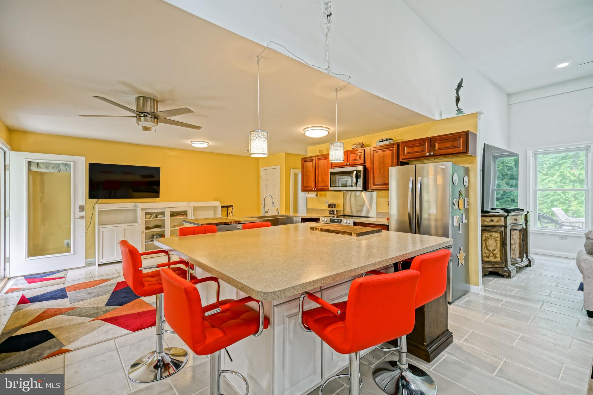 18897 Sand Hill Road Milton, DE 19968 - Photo 9 of 51 a view of a dining room with furniture and a kitchen