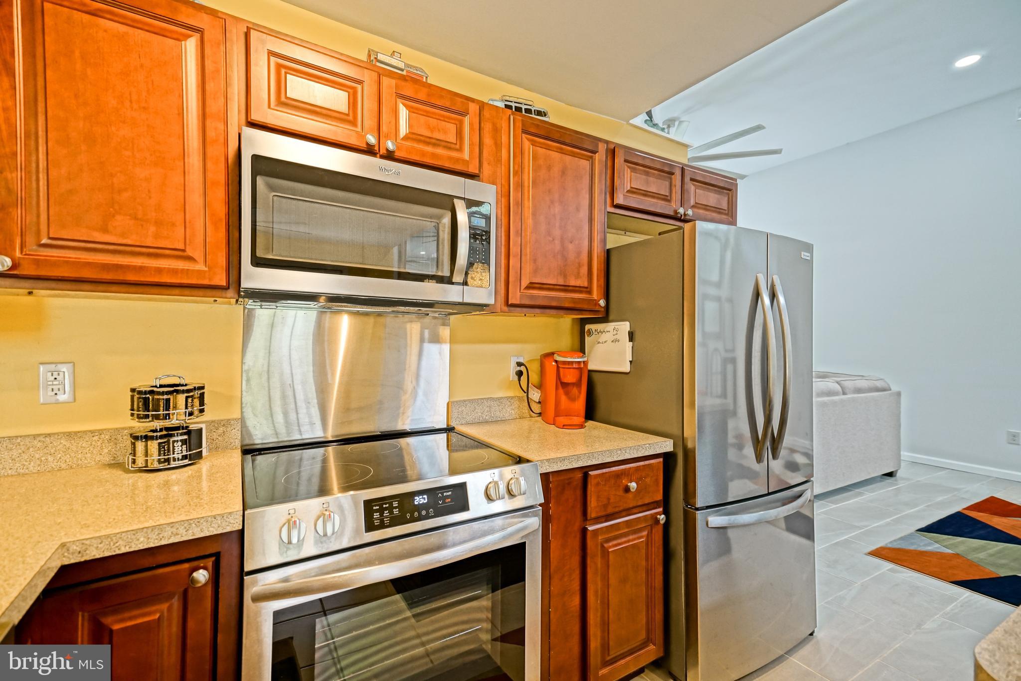 18897 Sand Hill Road Milton, DE 19968 - Photo 10 of 51 a kitchen with stainless steel appliances a stove microwave and refrigerator