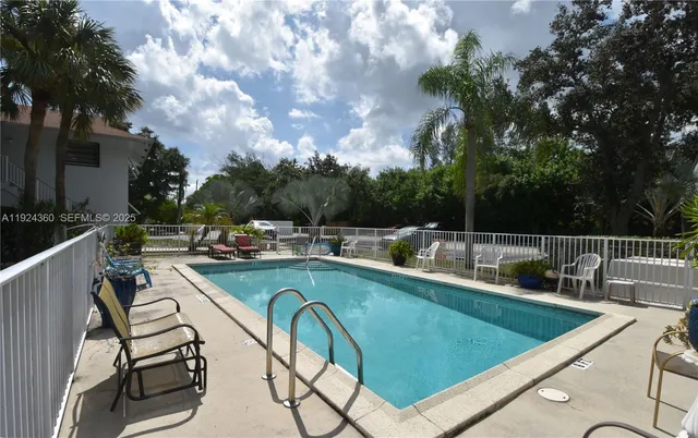 a view of a swimming pool with chairs