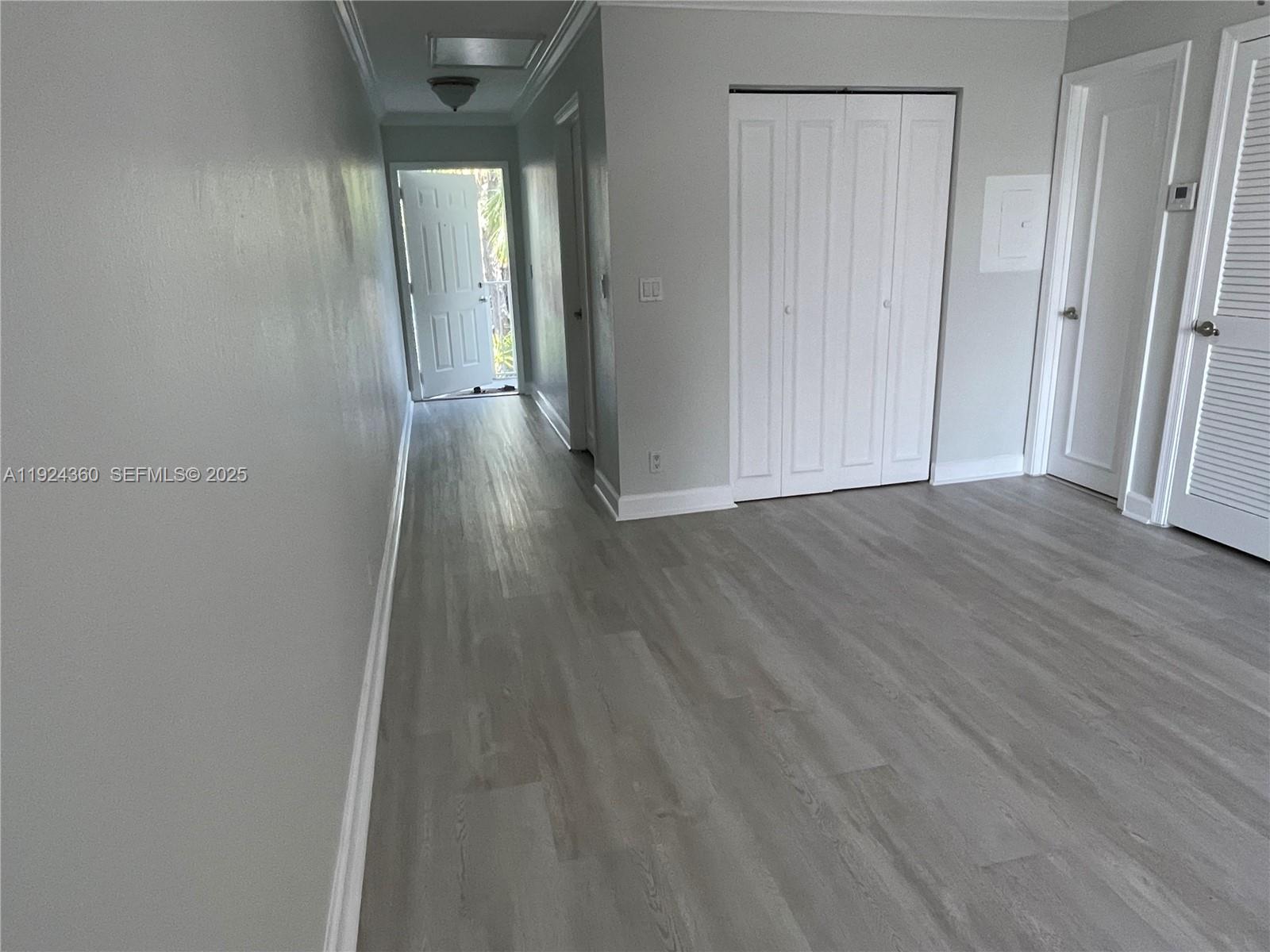 1401 Northeast 53rd Street, Unit 211 Fort Lauderdale, FL 33334 - Photo 4 of 14 a view of a hallway with wooden floor