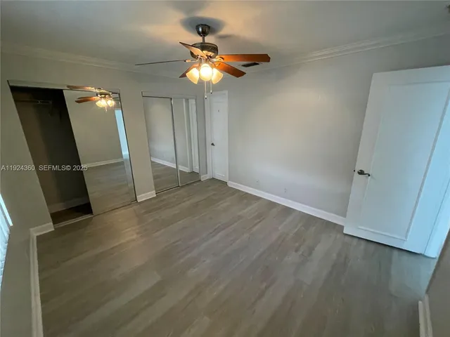 wooden floor in an empty room with a mirror