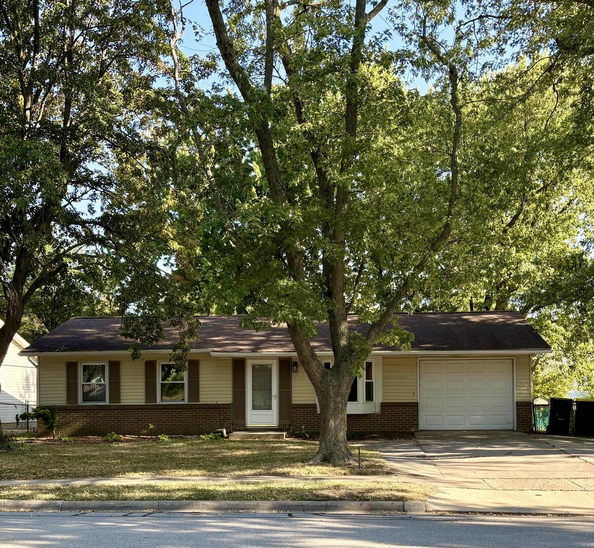 a house that has a tree in front of it