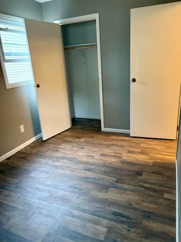 an empty room with wooden floor