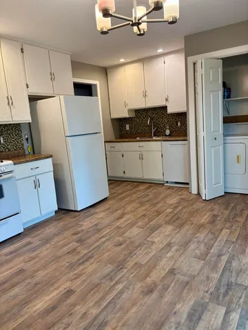 a view of a kitchen with wooden floor