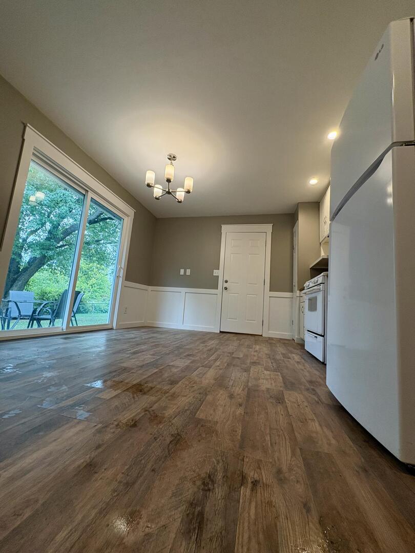 1401 Dillon Drive Normal, IL 61761 - Photo 4 of 17 an empty room with wooden floor and windows