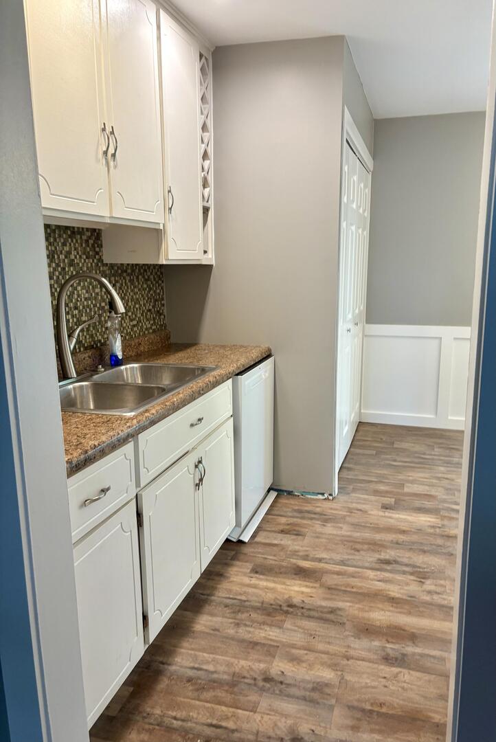 1401 Dillon Drive Normal, IL 61761 - Photo 7 of 17 a kitchen with granite countertop white cabinets and sink