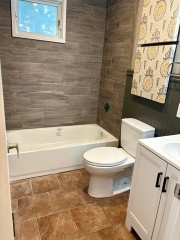 a bathroom with a toilet and a bathtub
