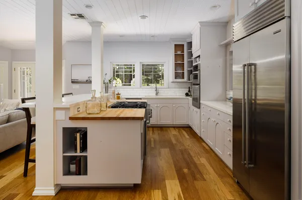 a kitchen with stainless steel appliances granite countertop a sink and a stove
