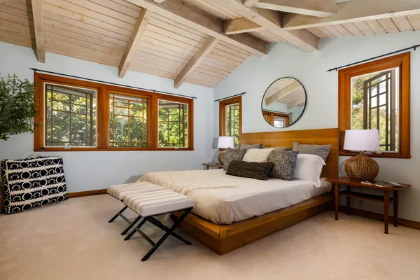 a bedroom with a bed and ceiling fan