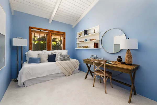 a bedroom with a bed and window