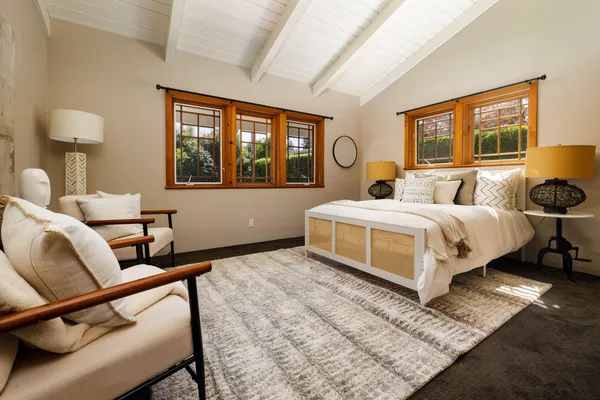 a bedroom with a bed and a painting on the wall