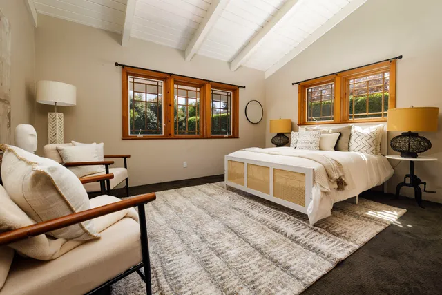 a bedroom with a bed and a painting on the wall