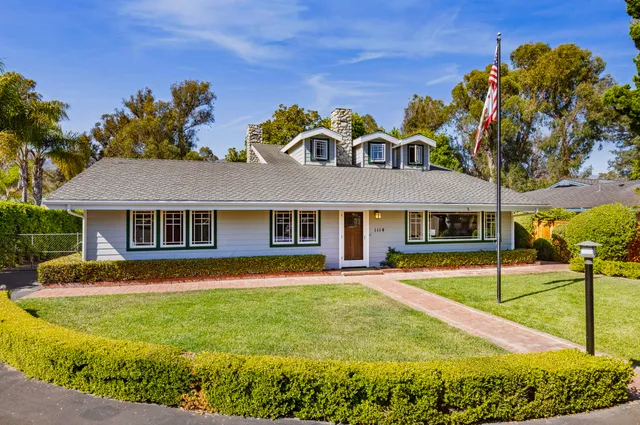 a front view of house with yard and green space