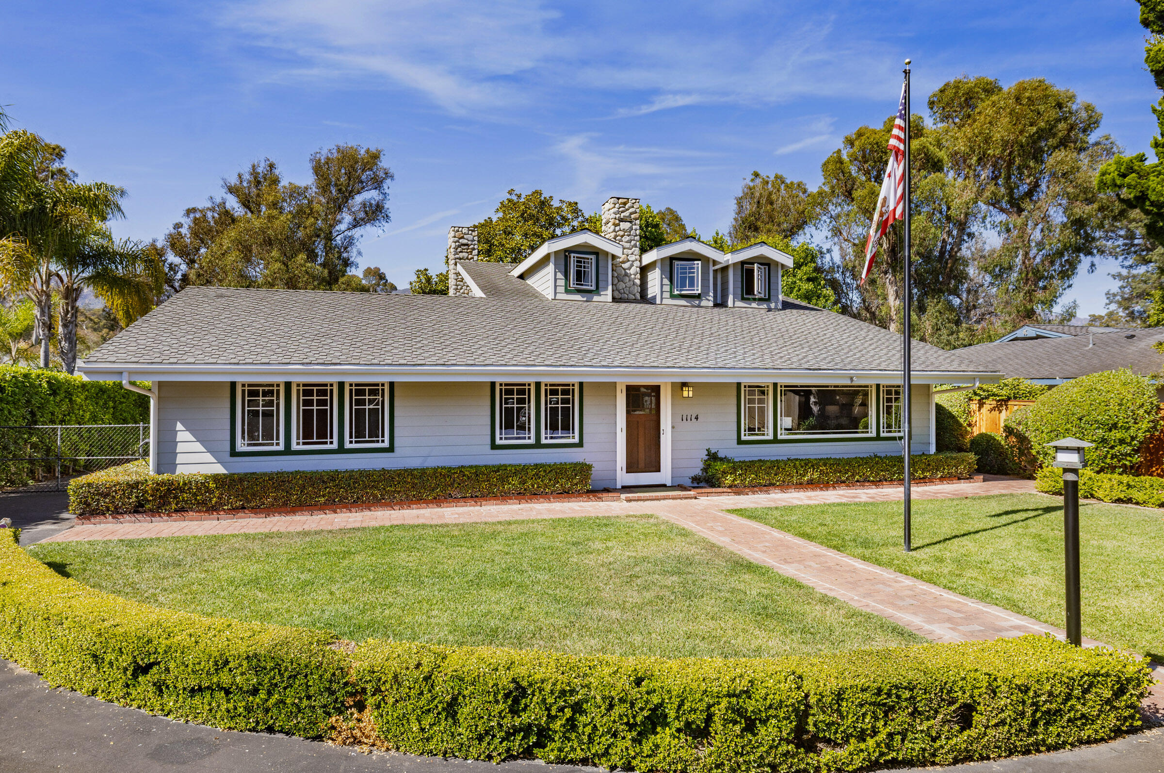 1114 Hill Road Montecito, CA 93108 - Photo 2 of 27 a front view of a house with a yard table and chairs