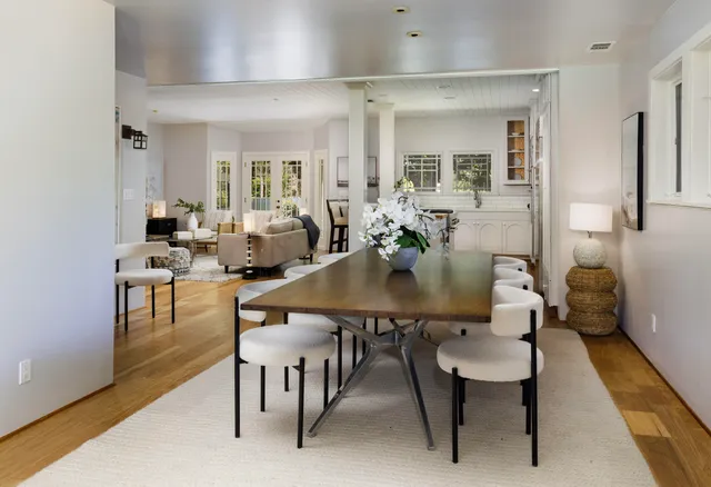 a living room with furniture a fireplace and a large window