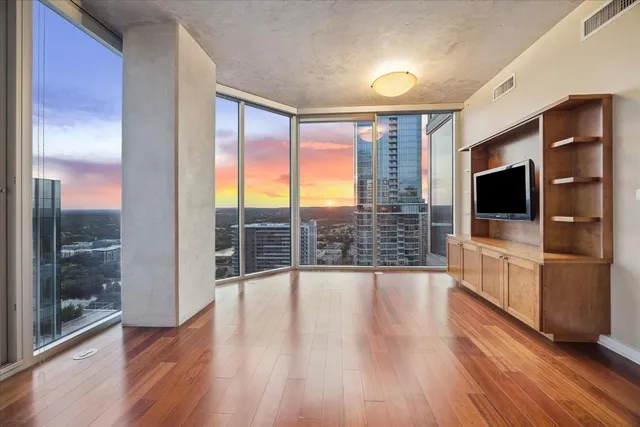 a view of a living room with hardwood floor and a flat screen tv