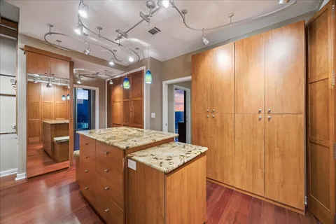 a view of a living room with hardwood floor and a flat screen tv