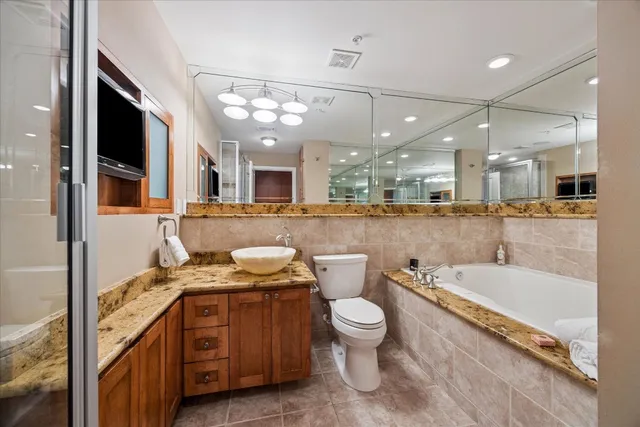 a large white kitchen with a large island