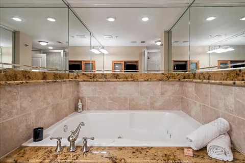 a large white kitchen with a large island