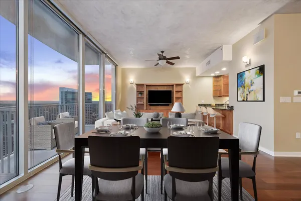a living room with furniture and a floor to ceiling window