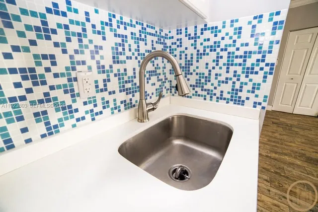 a close view of a sink a faucet and a shower curtain