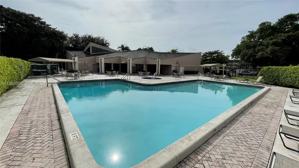 an aerial view of a house with pool table and chairs