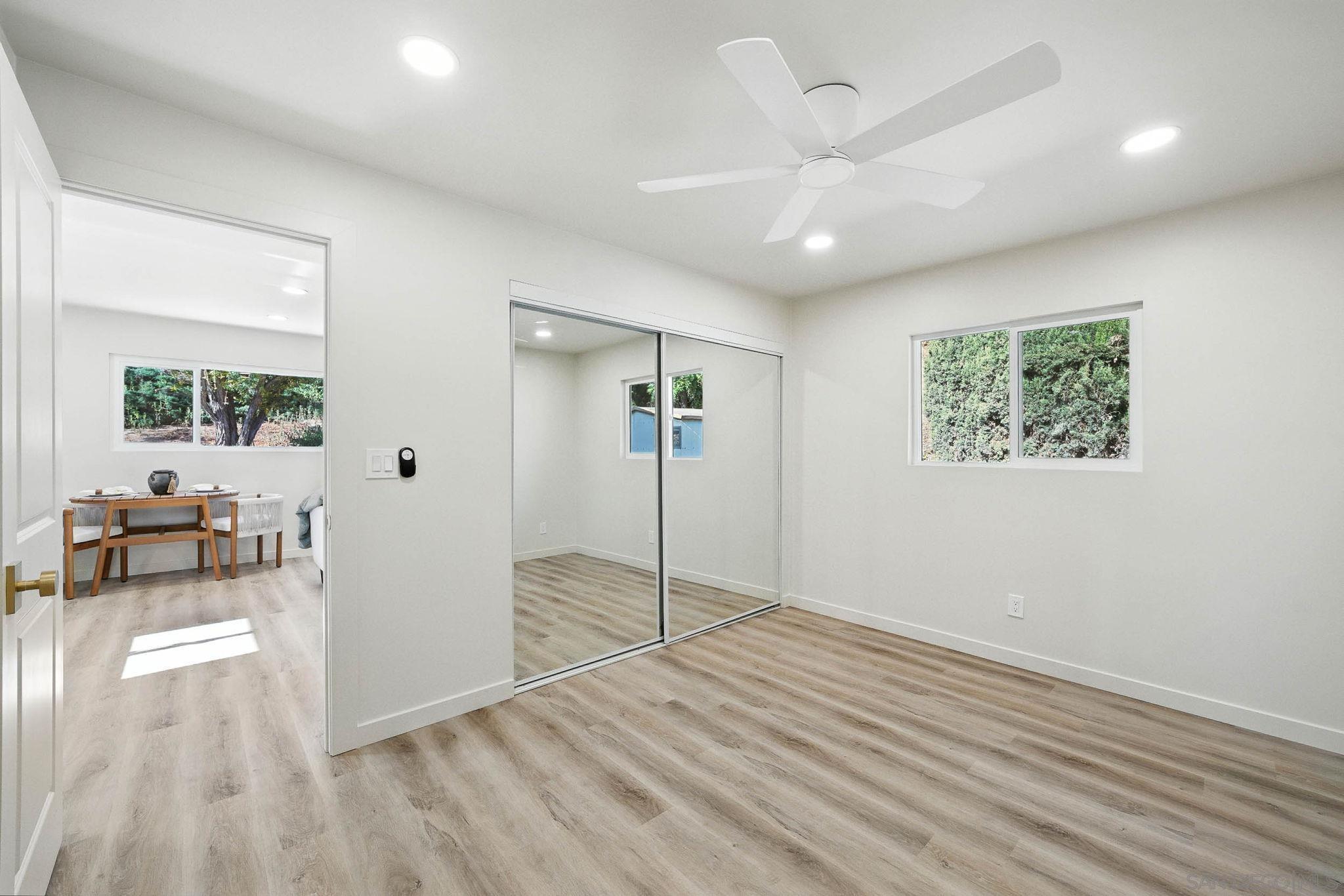 10183 Madrid Way Spring Valley, CA 91977 - Photo 30 of 52 a view of empty room with wooden floor and fan