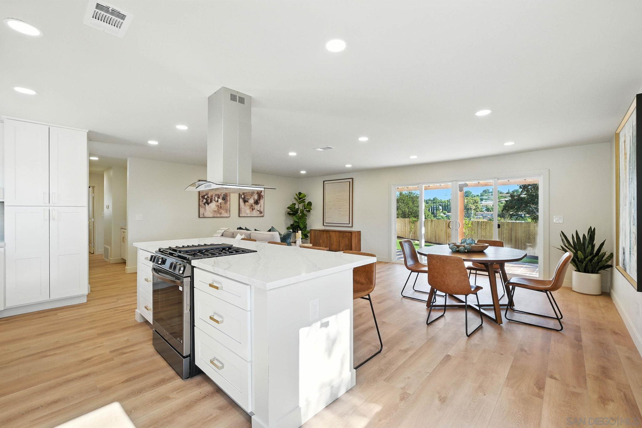 10183 Madrid Way Spring Valley, CA 91977 - Photo 6 of 52 a kitchen with a stove and wooden floor