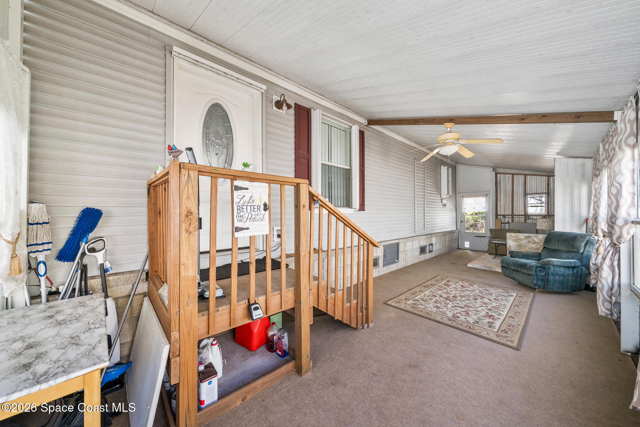 1854 Mango Street Northeast Palm Bay, FL 32905 - Photo 23 of 35 a living room with furniture staircase and a dining table