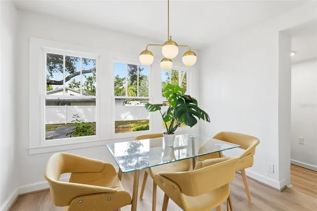 a view of a dining room with furniture and a large window
