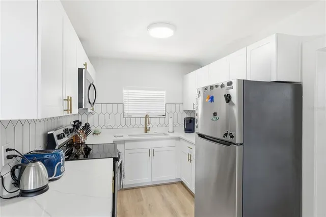 a kitchen with a refrigerator and a sink