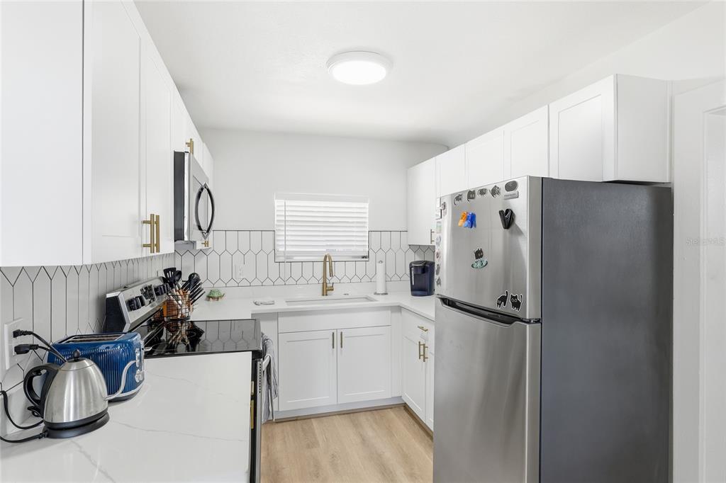 3011 6th Street Sarasota, FL 34237 - Photo 12 of 23 a kitchen with a refrigerator and a sink