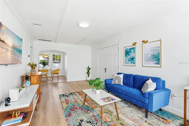 a living room with furniture and wooden floor