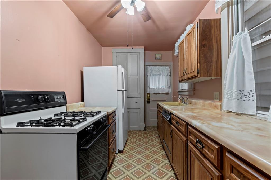 24 High Street Pittsburgh, PA 15223 - Photo 4 of 12 a kitchen with stainless steel appliances granite countertop a stove and a refrigerator
