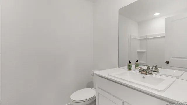 a bathroom with a sink a toilet and mirror