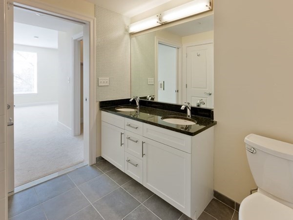 7 Cameron Avenue, Unit 102 Cambridge, MA 02140 - Photo 2 of 12 a bathroom with a granite countertop sink and a toilet