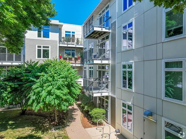 a front view of a building with a garden