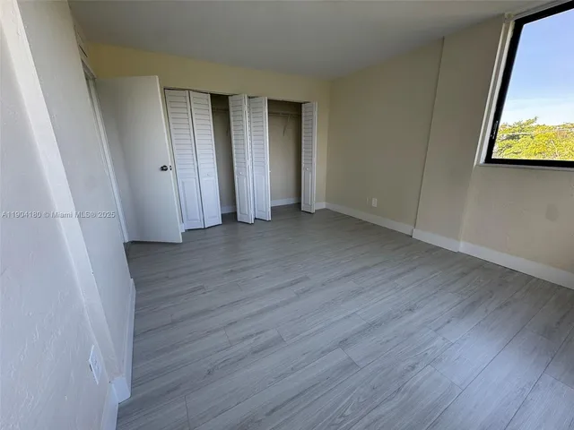 a view of a room with wooden floor and wall