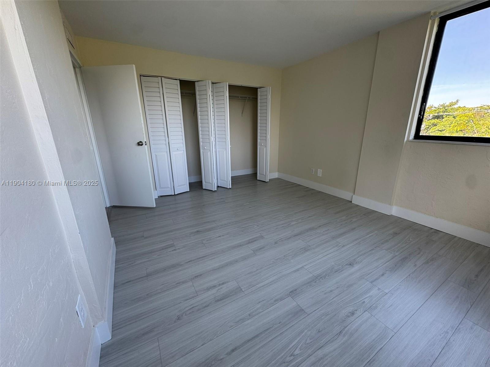 2715 Tigertail Avenue, Unit 404 Miami, FL 33133 - Photo 11 of 22 a view of a room with wooden floor and wall