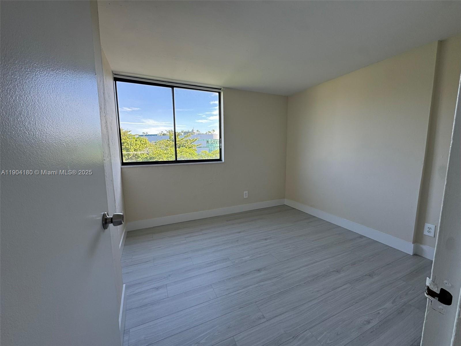 2715 Tigertail Avenue, Unit 404 Miami, FL 33133 - Photo 12 of 22 an empty room with window