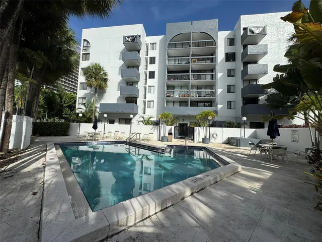 a large building with a pool table and chairs