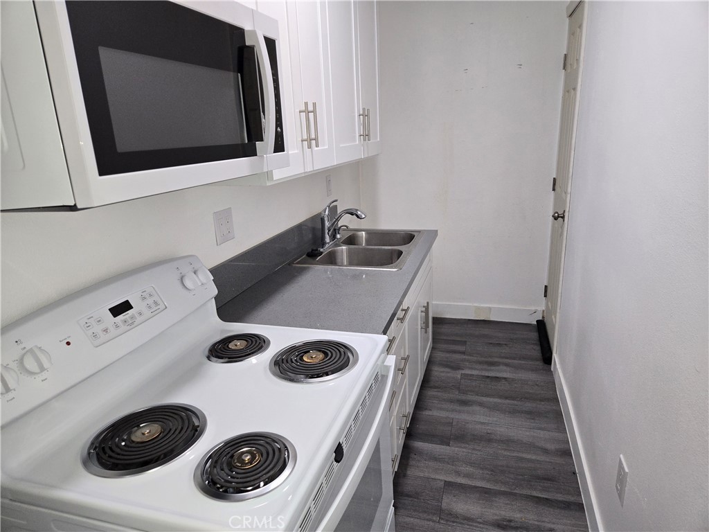 5327 Tyler Street, Unit B Riverside, CA 92503 - Photo 4 of 4 a kitchen with a stove and white cabinets
