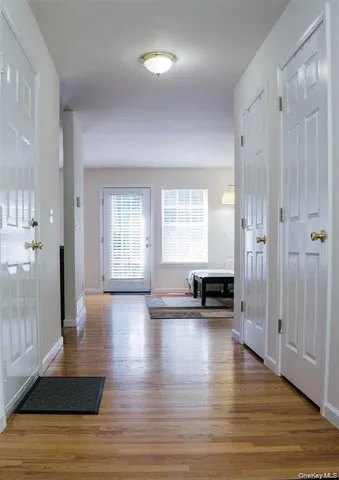 a view of empty room with a window and wooden floor