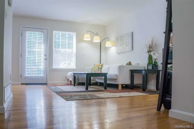a dining room with table and chairs with wooden floor