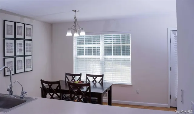 a view of a dining room with furniture and window
