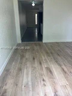 a kitchen with granite countertop a stove a sink and a refrigerator